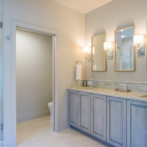 Double vanities with ample room, and water closet.