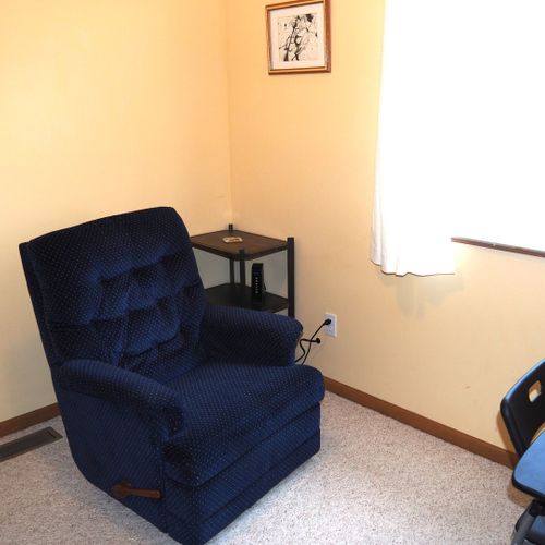 Office (main floor):  features a comfy chair, piano, dresser, and desk with chair.