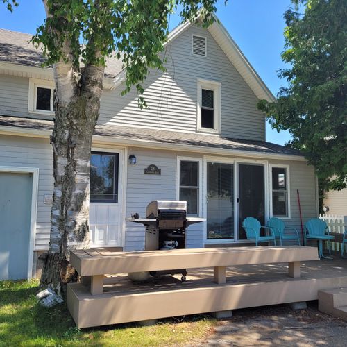 OVERVIEW:  The back deck with propane grill, seating, and lakeview!