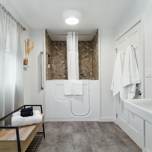 Main level bathroom with shower & handicap bathtub combo.