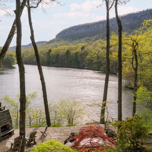 Your private oasis, comprised of terraced garden, outdoor fireplace and lake beyond.