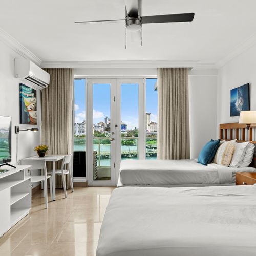 Enjoy bright natural light and a refreshing breeze from the ceiling fan in this cozy space.