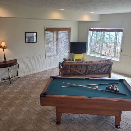 Gameroom (lower level):  the home has a fun gameroom on the lower level with a pool table, television with playstation2, and a sofa