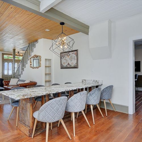 - open concept space featuring a striking stone dining table with seating for eight
- warm wood accents, unique lighting fixtures, and a cozy flow into the living room
- ideal for group meals, celebrations, or casual nights in with loved ones