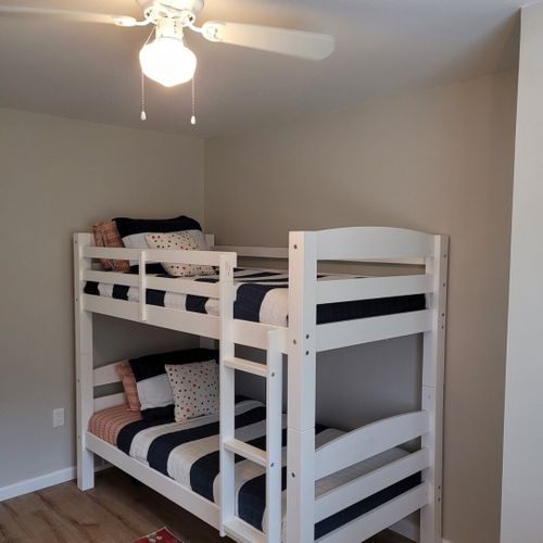 Bedroom #3:  bedroom #3 features a twin-on-twin bunk bed, ceiling fan, dresser, and closet.