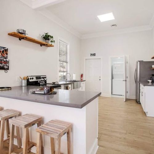 Kitchen & dining area w/ island seating — a natural hub for cooking & catching up.