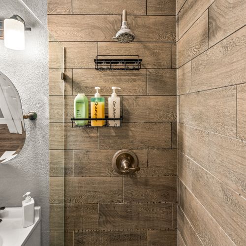 Freshen up in this walk-in shower featuring a peaceful design.