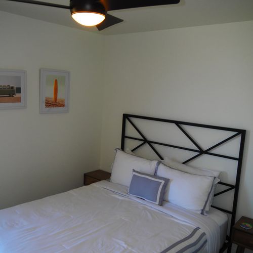 Bedroom #2:  features a queen-size bed, nightstands, desk, and a large wall closet.