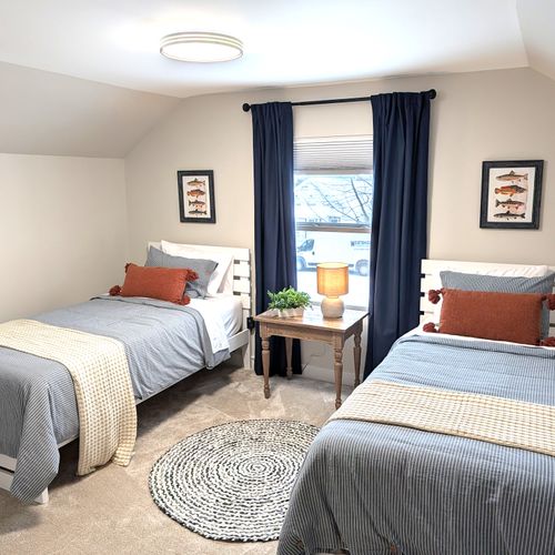 BEDROOM #2 (SECOND FLOOR):  Cute bedroom with two twin beds, table, lamp, dresser, and closet.