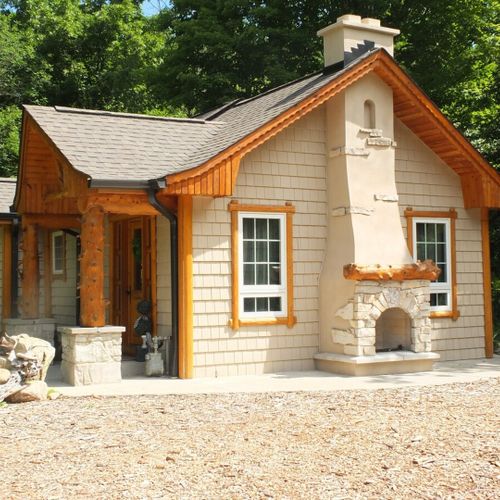 Exterior:  the south side of the house, highlighting the exterior wood fireplace.