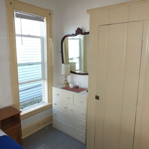 Bedroom #2 (main floor):  features a full-size bed, mirror, dresser, and closet.