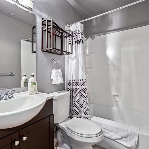 The upstairs hallway full bathroom includes a shower/tub combo, toilet, and sink, with toiletries provided.