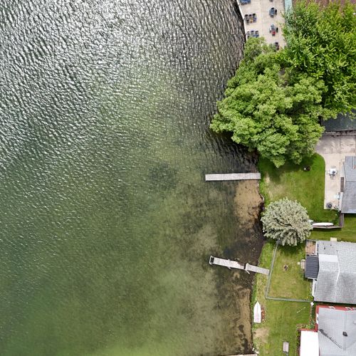 Overall:  a upper drone shot to show the house with the lake