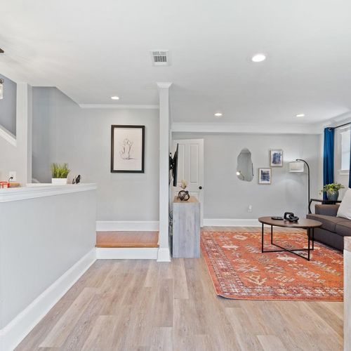 Open living, kitchen & staircase area w/ a bright, connected feel.