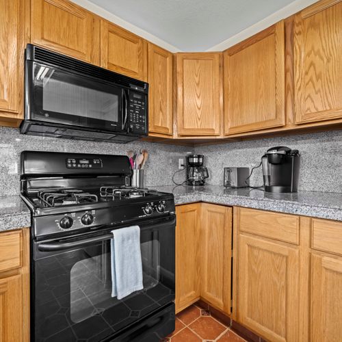 The full-size stove, microwave, and practical cooking setup is designed for easy home cooking