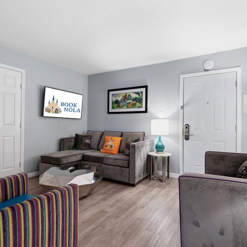 Bright living space w/ bold accent pillows & plenty of comfortable seating.