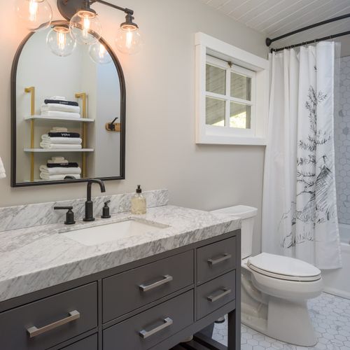 Bathroom with marble sink and a hot tub shower mix