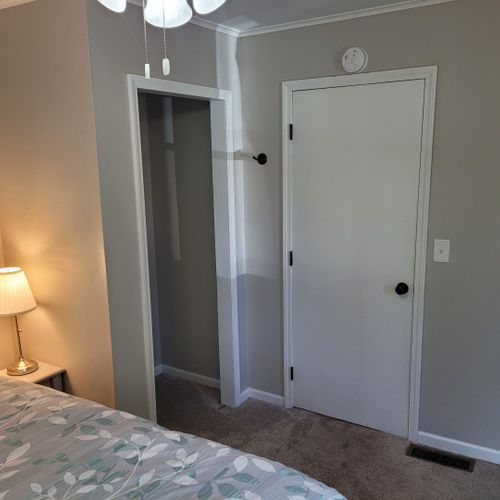 Bedroom #1:  features a queen-size bed, ceiling fan, nightstand, lamp, closet, and dresser.