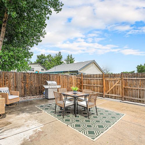 - private fenced yard offers a sunny spot for morning coffee or evening dining outdoors
- patio table and cushioned chairs provide comfortable seating for four guests
- grill and lounge setup make it a versatile backyard escape