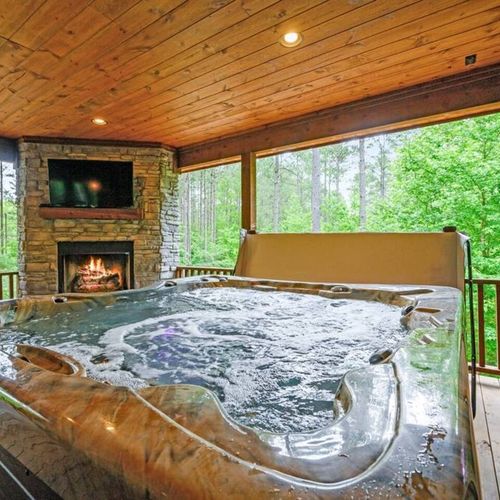 A large 8-person hot tub also sits on the patio around the fireplace.