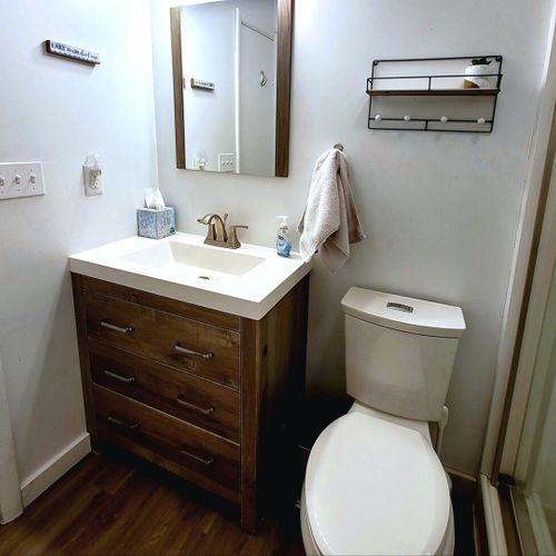 Full-bath:  the cottage has a lovely full bathroom with a shower, sink, vanity, mirror, and toilet.