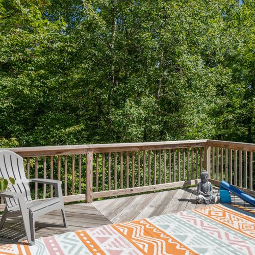 This peaceful space is located just off the primary bedroom, perfect for slow mornings surrounded by the trees.