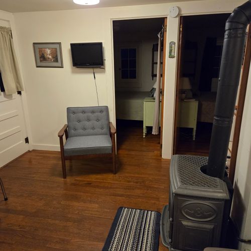 Living room:  the cabin has a cute little living room with a loveseat, dining table, and streaming television.