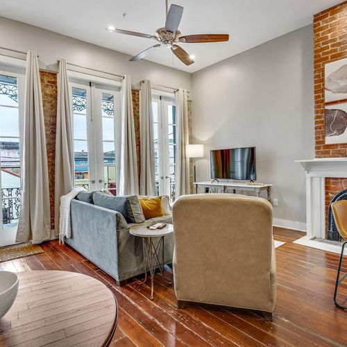 Bright living room w/ large windows & plush seating perfect for unwinding.