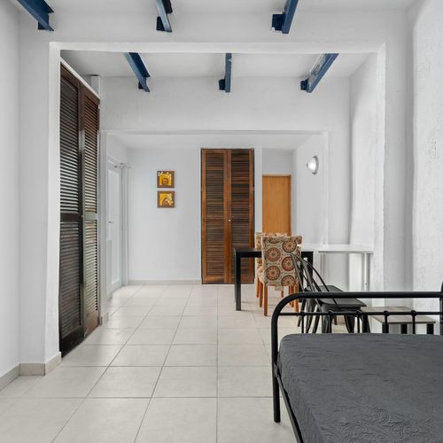 Unwind in an area adorned with contemporary furnishings, such as cozy patterned chairs and a stylish black dining table.