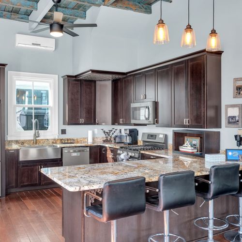 Chef's kitchen w/ a marble island — perfect for cooking up a group meal.