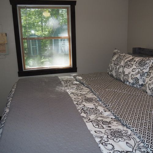 Bedroom #1 (main floor):  features a king-size bed, ceiling fan, dresser, mirror, closet, and a private television with live streaming via roku.