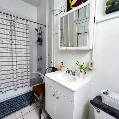 Bathroom w/ a tub/shower combo & a sink for a refreshing start to your day.