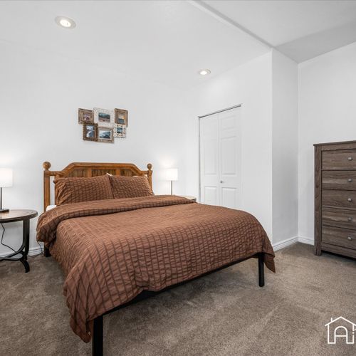 Retreat to the lovely downstairs bedroom with a comfortable queen size bed, providing a peaceful oasis.