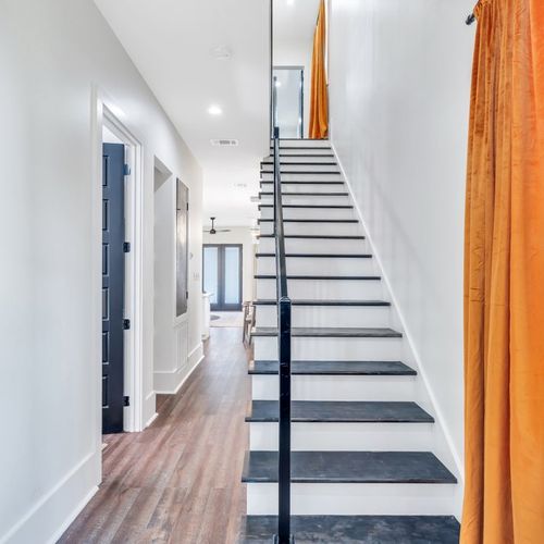 Entryway and staircase leading to bedrooms