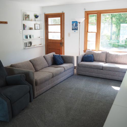 Living room:  the cottage has a very comfy and cozy living room with a sofa, loveseat, comfy chair, and television.