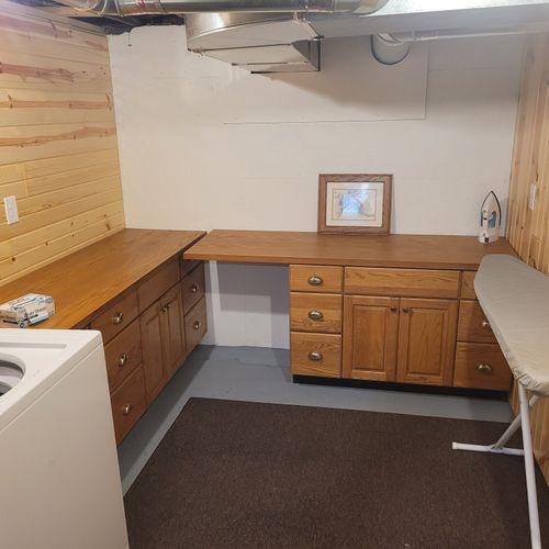 LAUNDRY ROOM:  There is a very convenient laundry room in the basement with a washer, dryer, ironing board, iron, and folding tables.