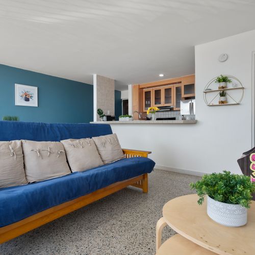 Cozy living space with comfortable blue sofa. Ideal for relaxation and making memories