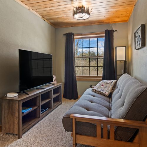 Loft:  features 2 twin-on-full bunk beds, twin bed, futon, television, and full bathroom.