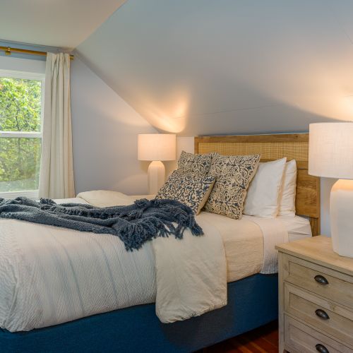 Upstairs, the guest Blue Room offers quality linens and comfort, plus a small view to the water and trees outside.