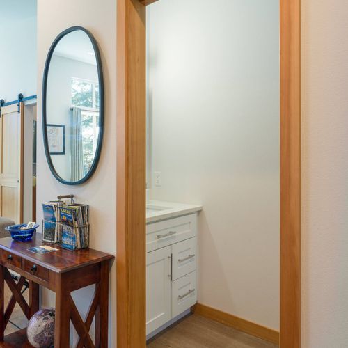 As you enter Tree Haven, the welcoming console and powder room are conveniently located.