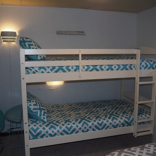 Bedroom #2:  features a full-size bed, bunk bed (i. E. 2 single beds on top of each other), ceiling fan, dresser, mirror, and closet.