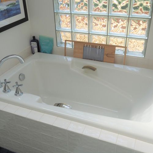 Bathroom #2 (main floor):  this is a private en suite bathroom for the master bedroom (bedroom #1). Features 2 sinks, a large bathtub, and separate shower and toilet facilities.