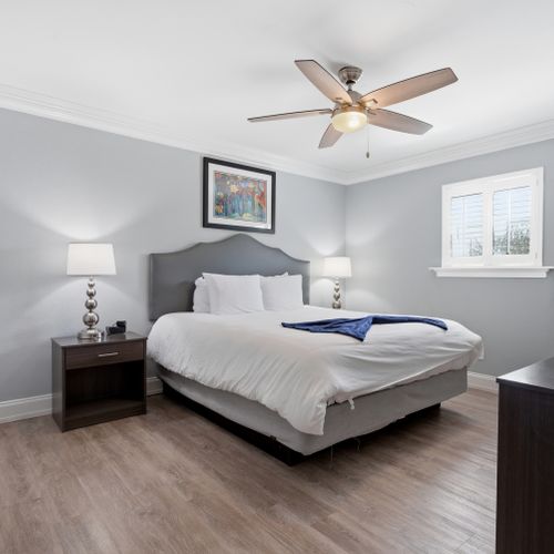 Bright bedroom w/ a cozy bed & soft natural light.