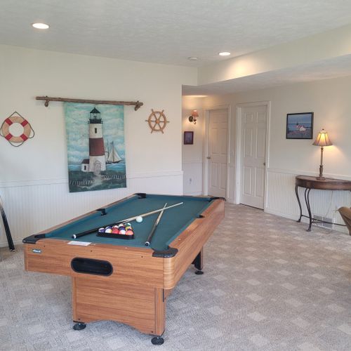 Gameroom (lower level):  the home has a fun gameroom on the lower level with a pool table, television with playstation2, and a sofa