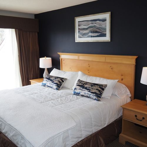 Master bedroom:  features a king-size bed, comfy chair, private balcony, nightstands with lamps, closet, its own television, and a private full en-suite bathroom!