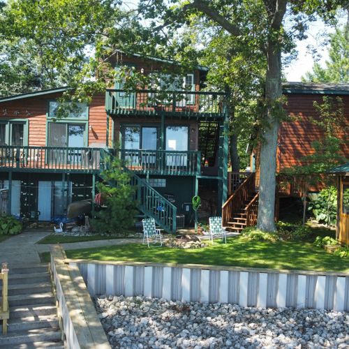 Exterior:  the back of the house, which faces the lake. The apartment is shown at the top of the photo.