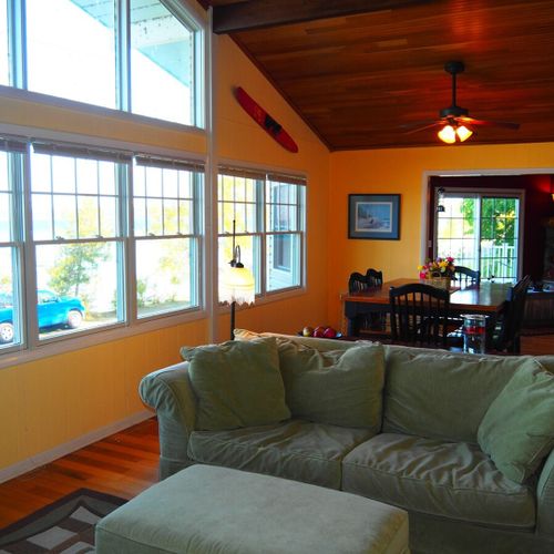 Upstairs living room:  the home has a beautiful living room with comfy furniture, a television with live streaming via roku, a ceiling fan, and spectacular views of crystal lake. (note that the fireplace is not for guest usage. )