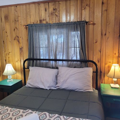 Bedroom #1:  features a queen-size bed, nightstands, lamps, a dresser, and a mirror.