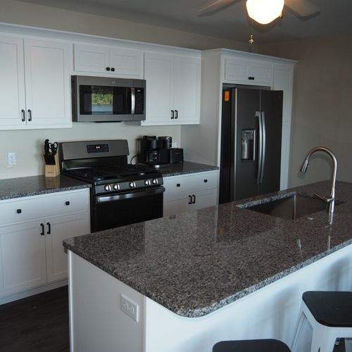 Kitchen:  newly remodeled and features a gas stove and stovetop, refrigerator, microwave oven, dishwasher, keurig coffee maker, toaster, island with sink, barstools, lots of counter space and cabinets, and a good supply of cooking & dining utensils.