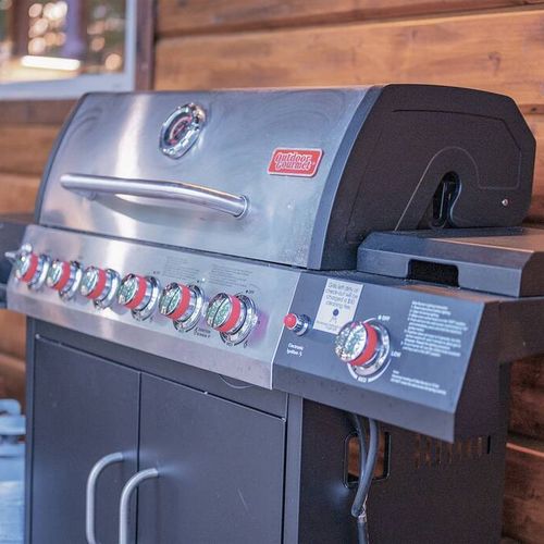 A gas grill for guests to use, propane provided.